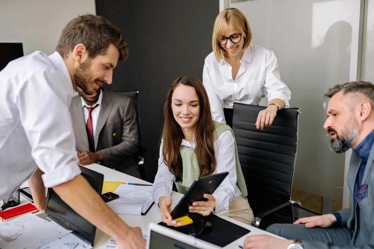 Colleagues discussing information on a tablet