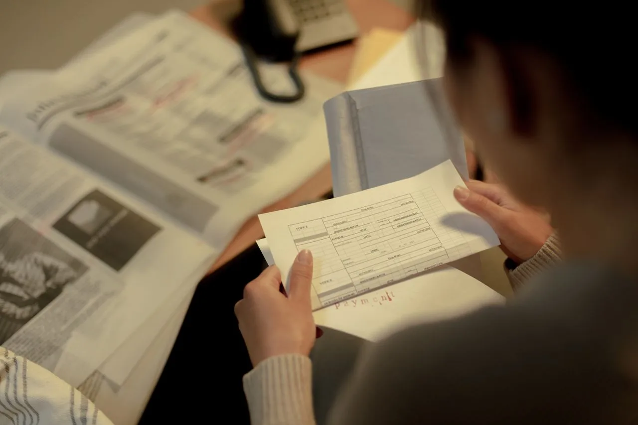 A woman reading printed job postings and application information