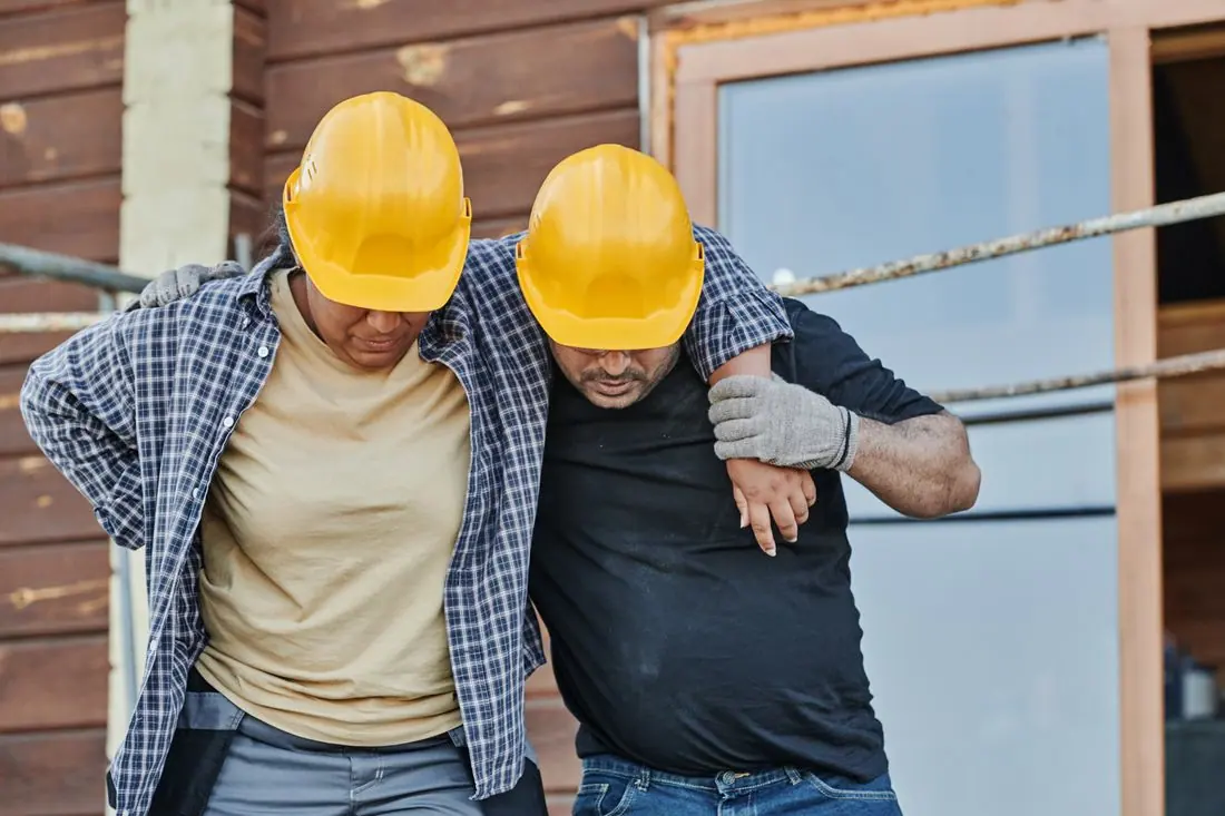 Colleagues supporting one another on a construction project